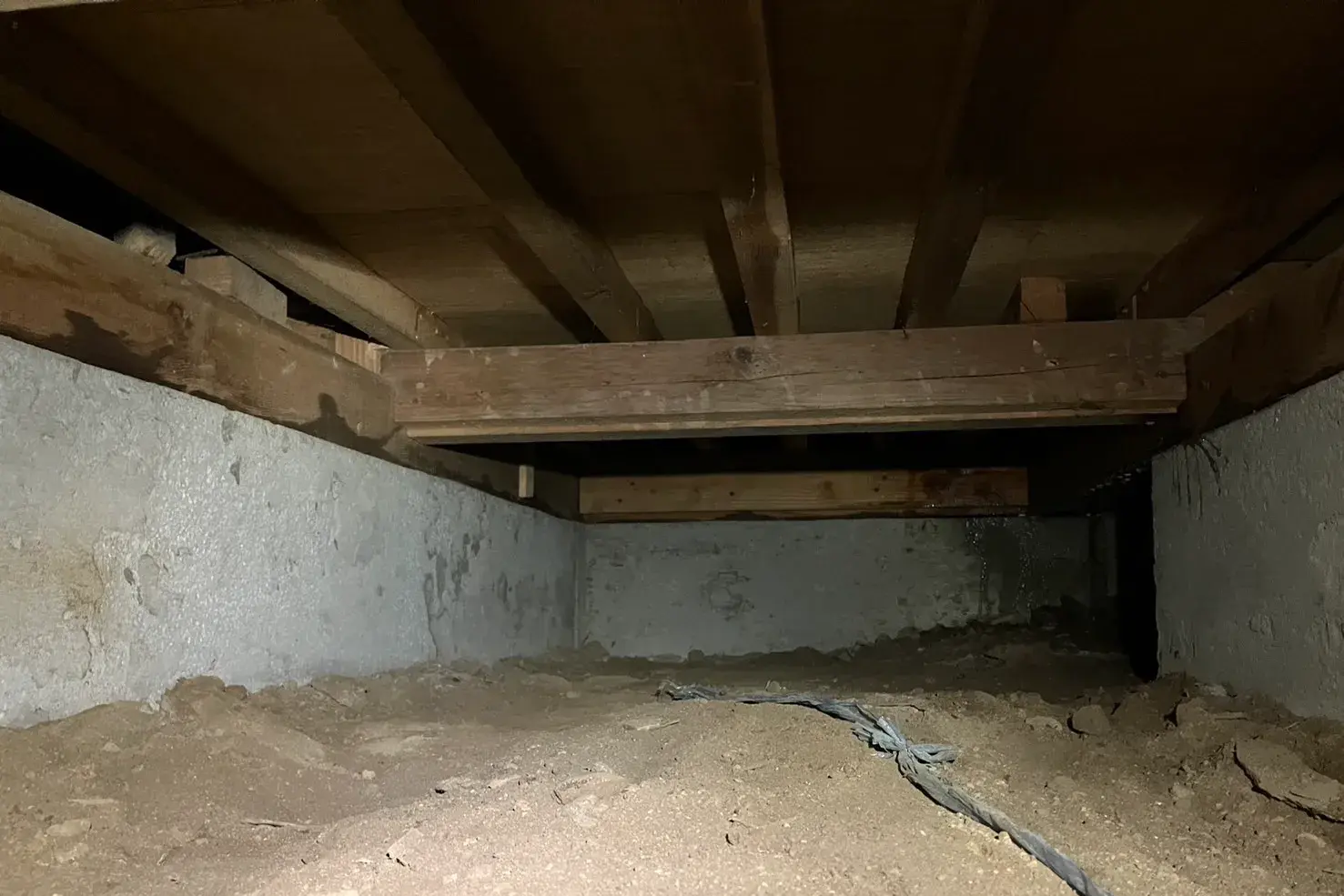 築60年の土壌床の基礎構造。土が露出した地面と木製構造材が見える床下